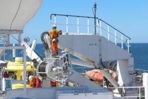 Workers perform maintenance duties aboard a ship, while wondering what a maritime injury is and where they can find a comprehensive guide.